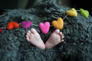 baby s feet covered with black wool textile